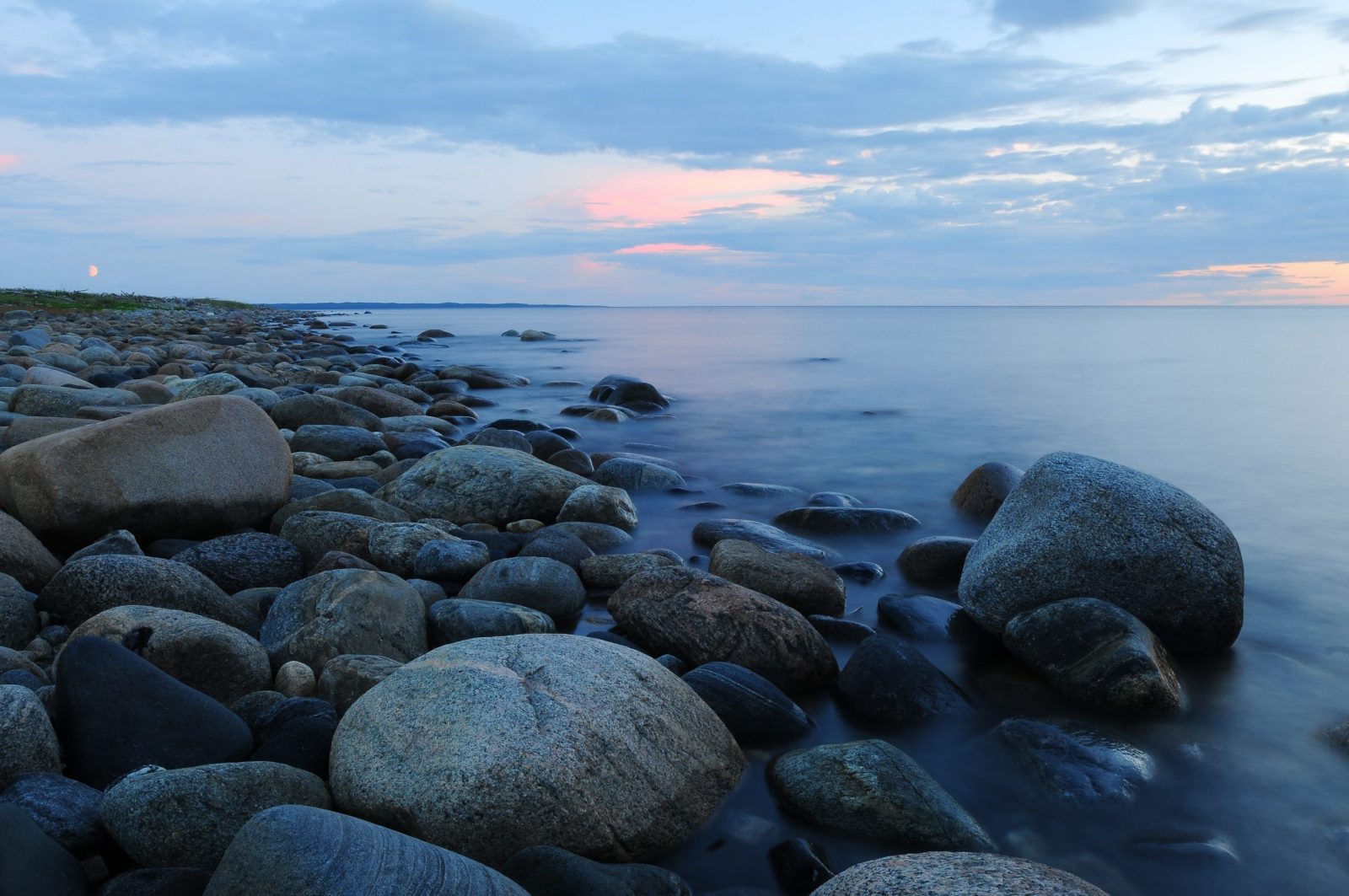 pebbles on beach against sky during sunset 258122 scaled